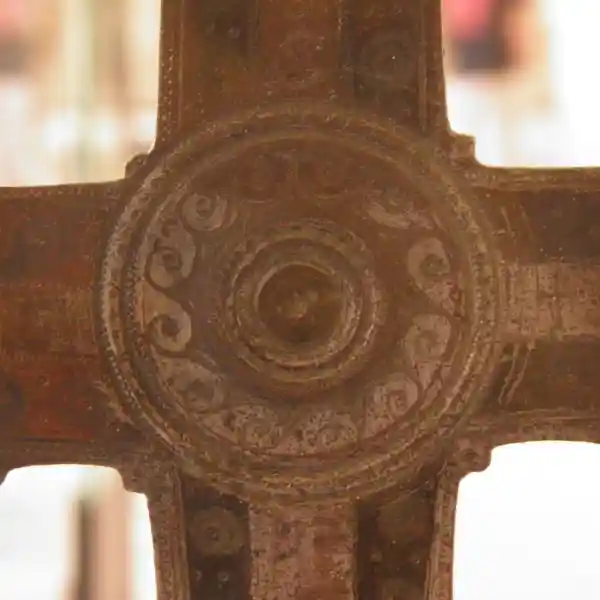 Close-up view of the central boss on a silvered bronze processional cross from early medieval Western Europe